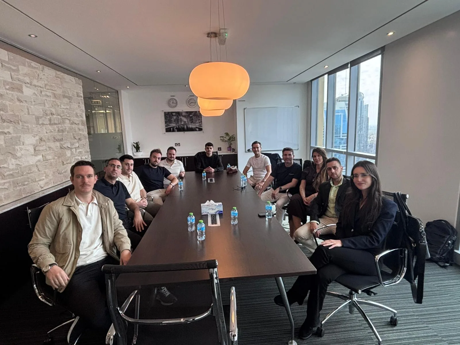 LorcaBase team with clients at the Dubai Marina office